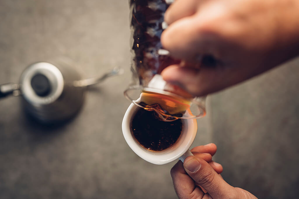 Man pouring coffee in mug