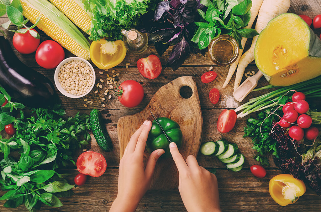 A woman cutting vegetables. 