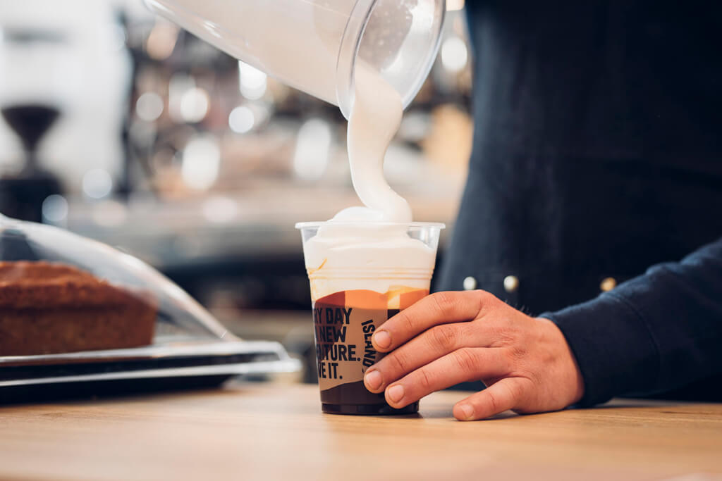 A Coffee Island's baristi preparing a freddo cappuccino. 