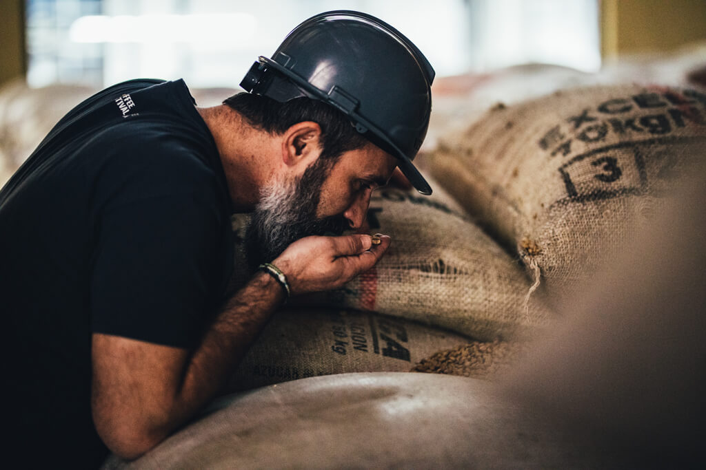 A man smelling coffee beans