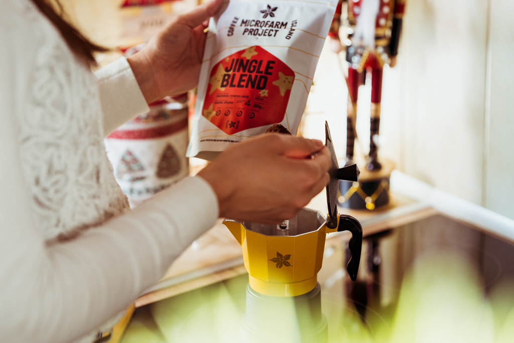 A woman preparing a Coffee Island jingle blend coffee. 