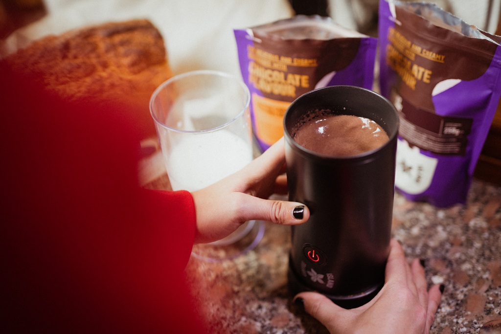 A woman preparing a Coffee Island hot chocolate. 