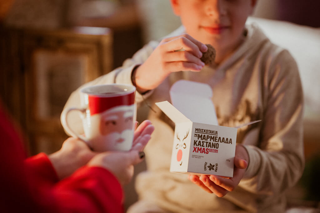 Coffee Island's Santa Claus mug and child eating Coffee Island's cookie bites.