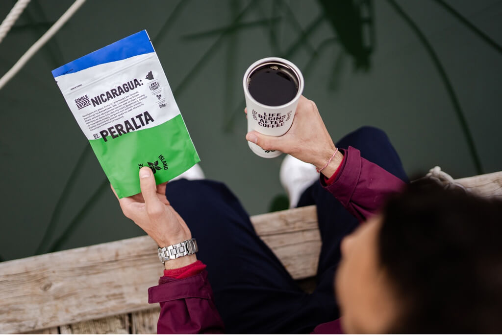 Man Holding A Reusable Cup of Nicaragua Coffee