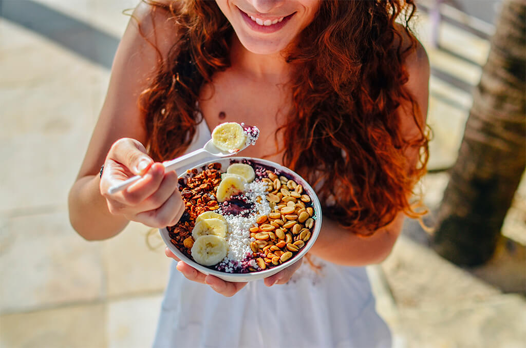 A Girl Eating her vegan acai bowl