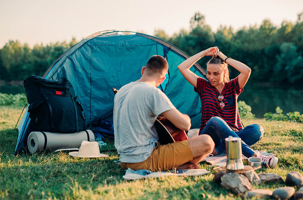 couple camping while drinking coffee