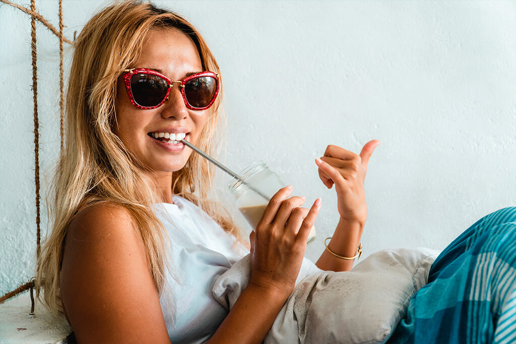 woman holding metallic straw