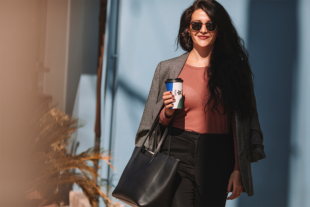 Woman walking with coffee in her hand