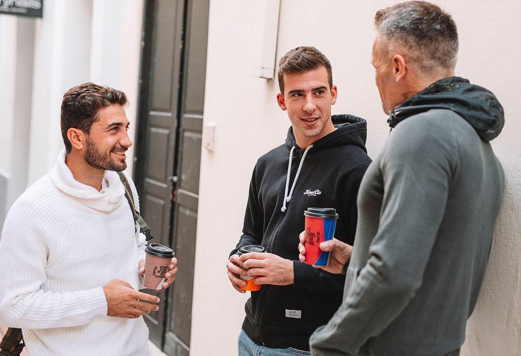 People smiling with coffee in their hands