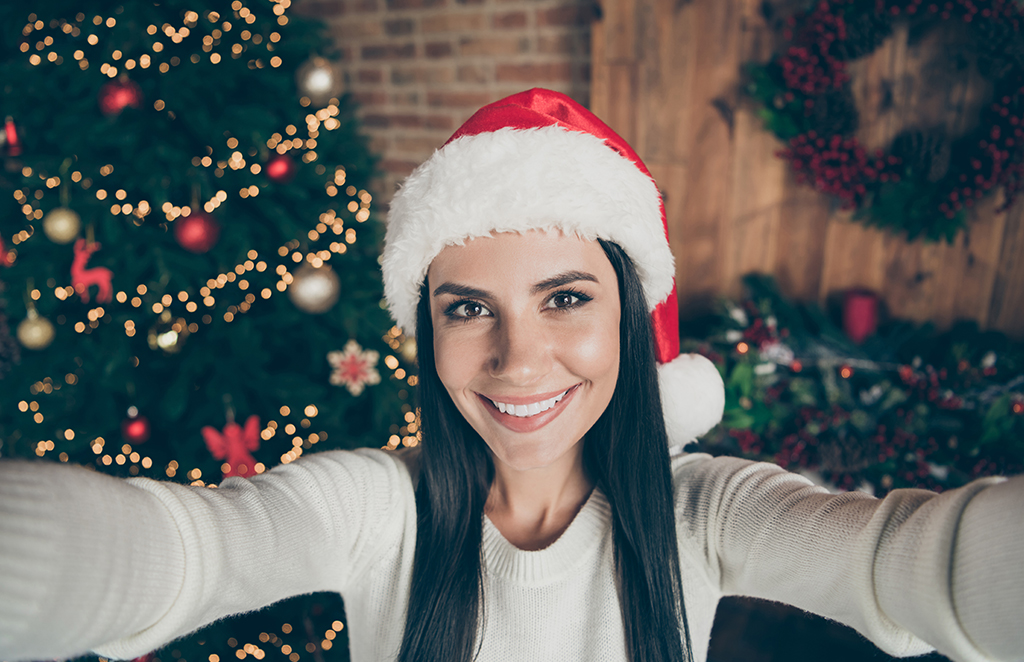 Woman smiling with christmas tree