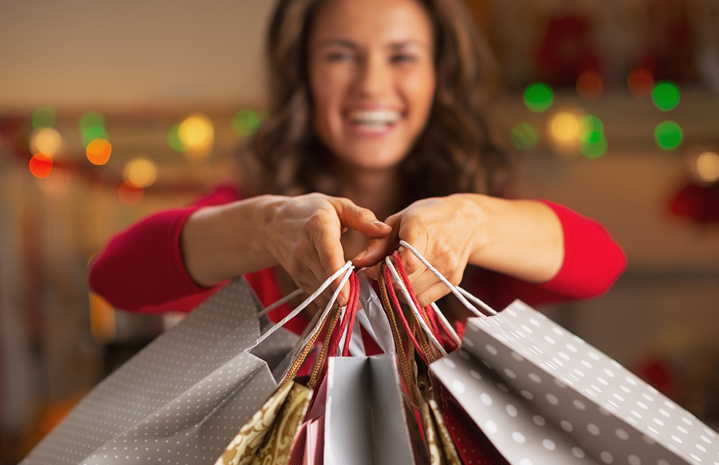 Woman smiling with christmas shopping bags