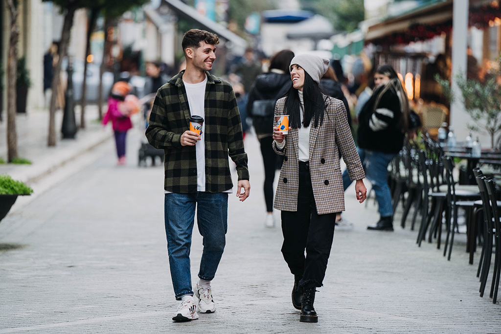 People walking with coffee and smile