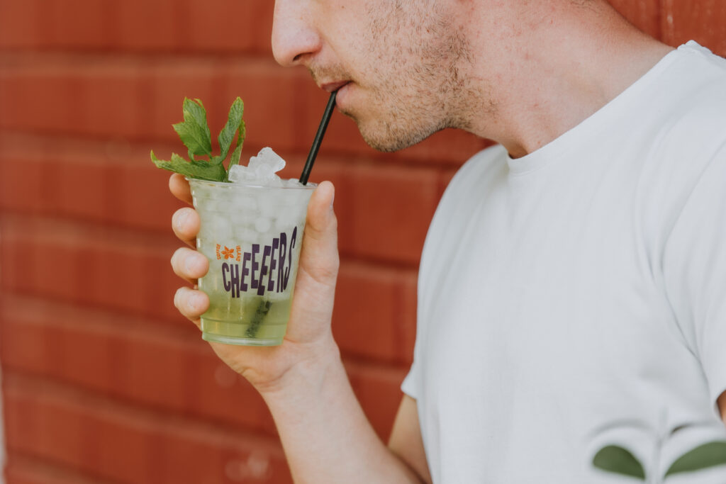 Person drinks from coffee island cup