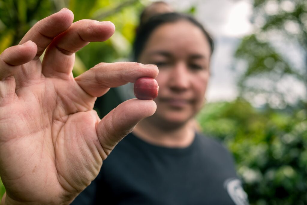 Woman with coffee beans.